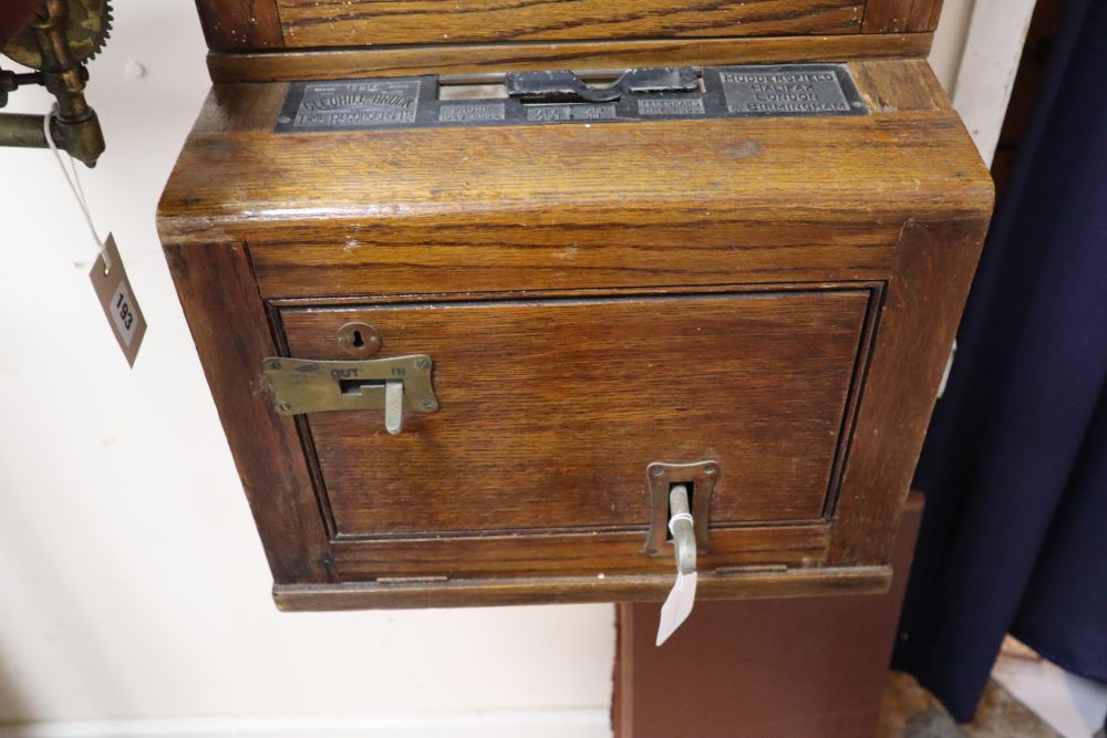 An early 20th century Gledhill-Brook oak cased clocking-in machine, width 40cm, depth 29cm, height 108cm